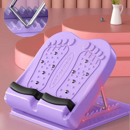 Purple foot exercise device on a pink surface with close-up inset showing metal component.
